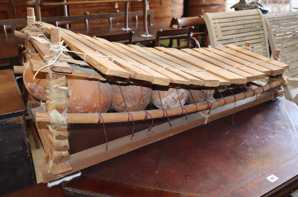 A Chinese wooden and terracotta xylophone, L.110cm